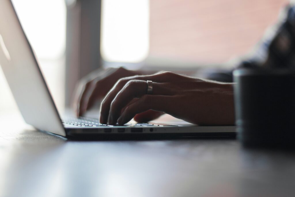 Image of someone typing on a laptop.